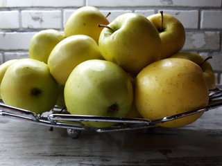 close-up of fruit, fresh juicy big yellow apples on an abstract surface