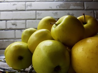 close-up of fruit, fresh juicy big yellow apples on an abstract surface