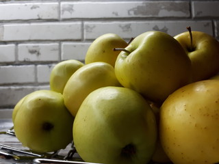 close-up of fruit, fresh juicy big yellow apples on an abstract surface
