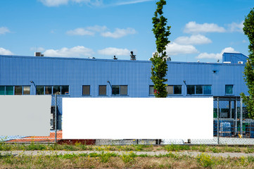Blank white banner for advertisement mounted on the fance of warehouse building