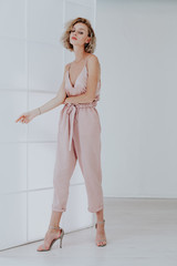 Portrait of a beautiful woman blonde in a fashionable jumpsuit