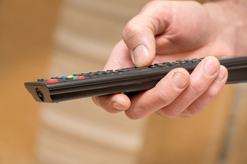 TV remote in the hand of man