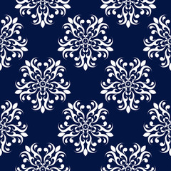 Floral seamless background. White pattern on dark blue backdrop