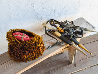 Several daggers on a bench near a Cossack hat