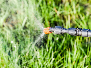 Spraying herbicide from the nozzle of the sprayer manual