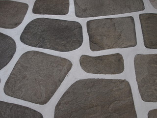Typical painted floor in the streets of the Mykonos island, Greece. Background of black and white stone floor texture. 