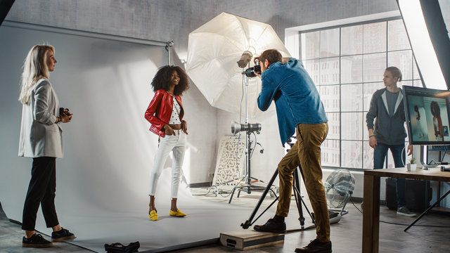 Behind the Scenes on Photo Shoot: Beautiful Black Model Poses for a Photographer, he Takes Photos with Professional Camera. Stylish Fashion Magazine Photoshoot done with Pro Equipment in a Studio