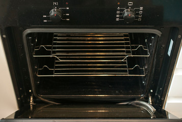 A torn oven door seal hanging out of place.