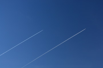 two chemtrails or contrails of airplanes in sky