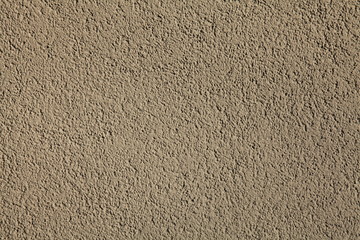 Cement textured coating, texture, background. Structural plaster, rough, uneven surface in brown or gray color. Modern exterior cladding of multi-story buildings