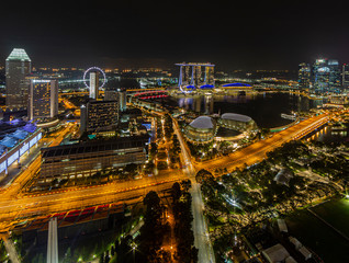 Fototapeta na wymiar Aerial panoramic picture of Singapore skyline and gardens by the bay during preparation for Formula 1 race in the night in autumn