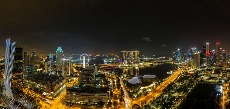 Aerial panoramic picture of Singapore skyline and gardens by the bay during preparation for Formula 1 race in the night in autumn