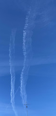 Obraz na płótnie Canvas Chemtrails in the blue sky