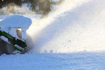 street cleaning the city from snow with the help of special machinery