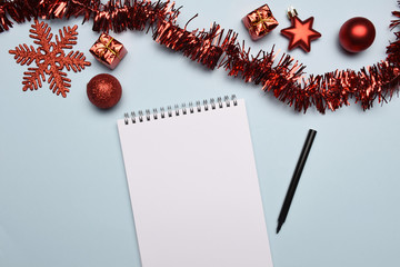 Fototapeta na wymiar Christmas decoration on the desk with blank note pad, to do list