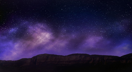 Night sky stars on mountains background.