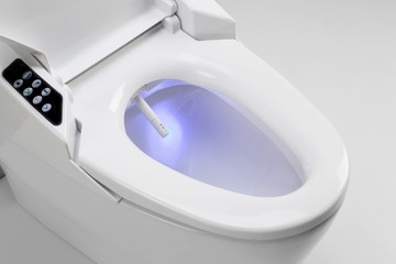 Toilet bowl with electronic high technology. Blue light in toilet bowl electronic Japan - obrazy, fototapety, plakaty