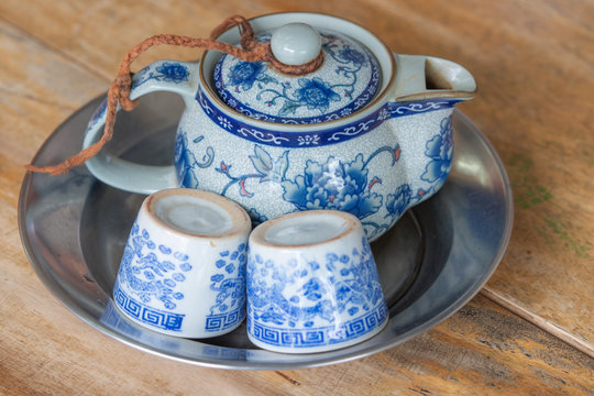 Chinese teapot and tea cups on wooden table