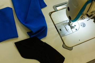 Sewing clothes, sewing equipment, detail of sewing machine, blue fabric, textile