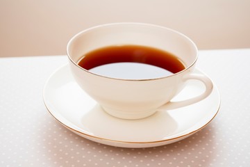 tea in a white cup on a saucer