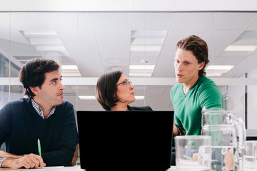 Group of office workers at a meeting around the boss