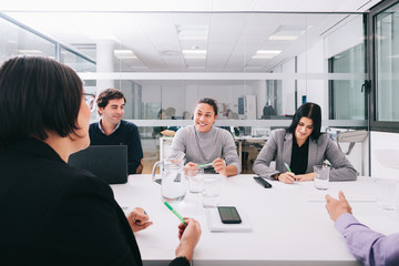 Group of office workers at a meeting around the boss