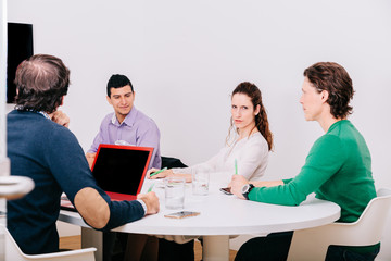 Group of office workers at a meeting around the boss