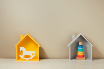 Wooden houses, pyramid and rocker horse on the shelf