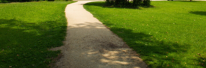 Obraz premium Hiking trail in city park. Summer season June.