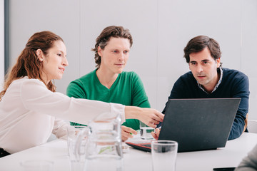 Group of office workers at a meeting around the boss