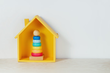 Yellow house and pyramid on the shelf in the kids room