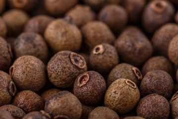 fresh spicy peppers allspice on white acrylic background