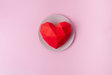 Paper volume heart on the plate on pink background with copy space