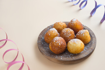 Carnival italian fritters in carnival on brown background