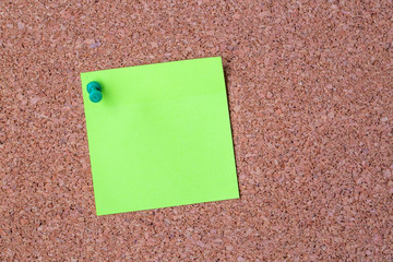 Cork board with several colorful blank notes with pins