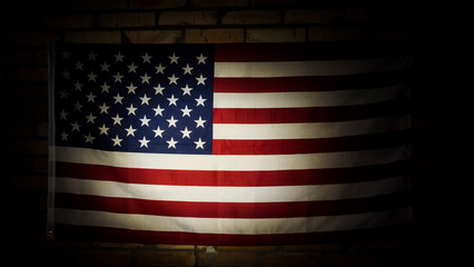 U.S. flag in the dark illuminated by spotlight