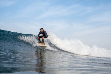 surfer riding waves on the island of fuerteventura
