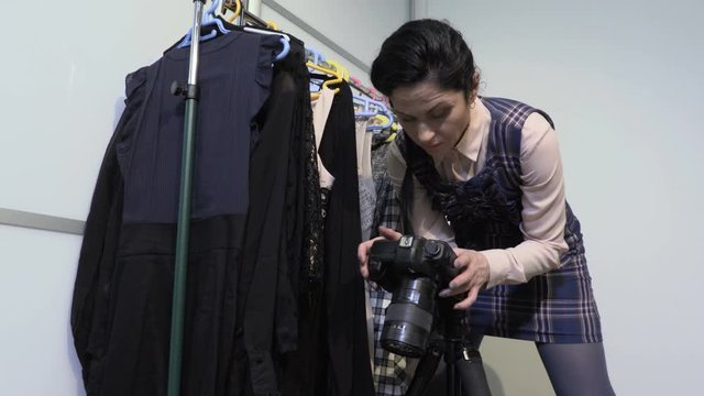 Female Fashion blogger take pictures of clothes on camera
