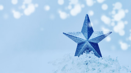Christmas blue star decorating the Christmas tree. New Year concept and trendy blue classic hue 2020.