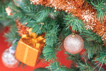 Fototapeta na wymiar Beautiful Christmas gift boxes hanging from a decorated Christmas tree