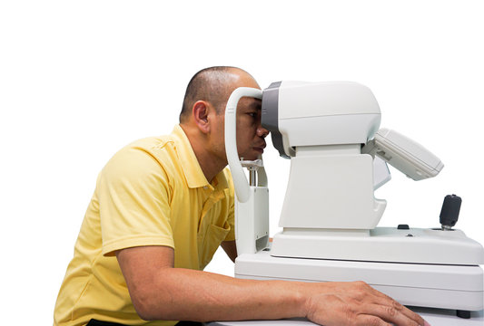 Asian man ophthalmologist to check quality of eye vision.