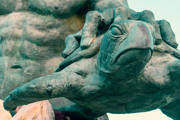 Fototapeta na wymiar Neptune statue close-up of turtle