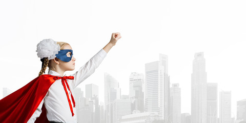 Girl power concept with cute kid guardian against cityscape background