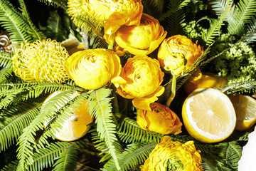 Lemons and yellow peony on a plate. Exotic tropic banquet decoration. Top view, closeup © Angelov