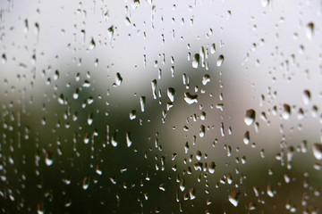Rain drops on glass window during thunder shower rain storm