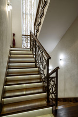 Interior of residential house. Nice staircase with LED lights. Home interior design in modern style.