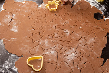 Cutting figures from the dough using special stencils for making ginger Christmas cookies. Home,...