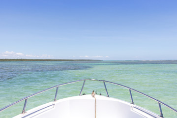 Top view of a yacht boat from natural pools in blue sea in Morro de Sao Paulo, Bahia, Brazil.