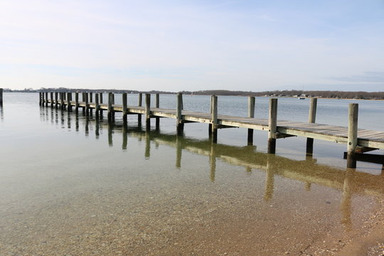 Old weathered wooden dock on a sandy coastal