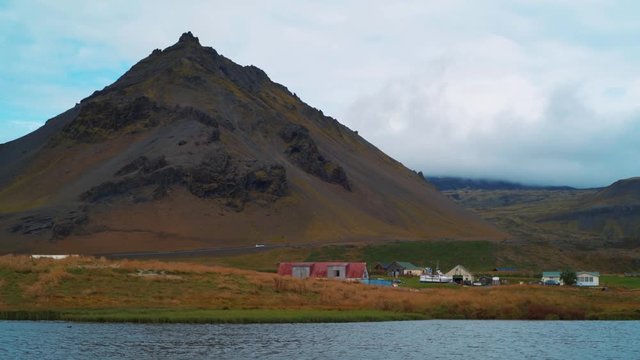 The small village of Hellnar across a lake, West Iceland